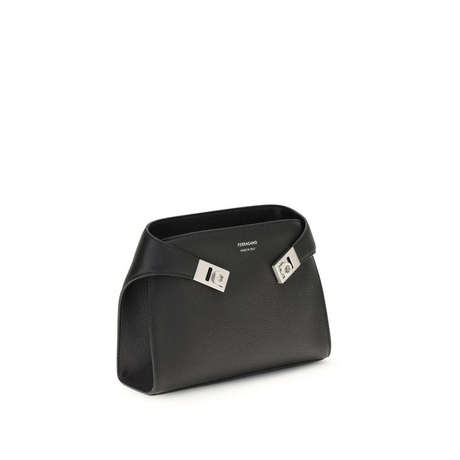 Leather Hug Fanny PackThe leather Hug Fanny Pack by Ferragamo reinterprets the iconic shapes of the collection in a compact and elegant version. Made of fine leather, it opens with a bridge and double magnet, revealing an interior also lined in leather. V