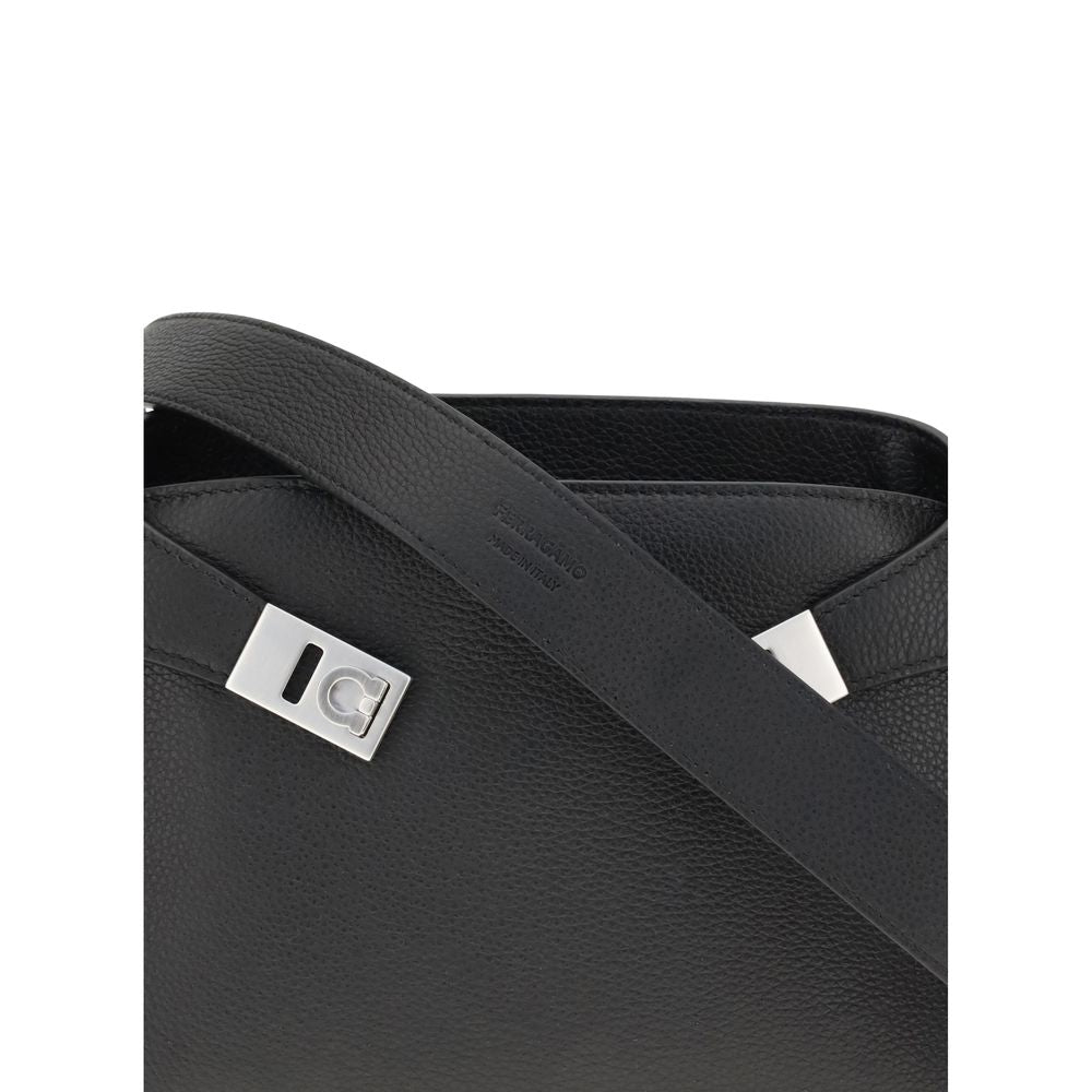 Leather Hug Fanny PackThe leather Hug Fanny Pack by Ferragamo reinterprets the iconic shapes of the collection in a compact and elegant version. Made of fine leather, it opens with a bridge and double magnet, revealing an interior also lined in leather. V