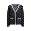 Black Wool CardiganGucci’s GG Supreme reversible Cardigan is made of fine wool tubular jacquard in shades of black and white with the iconic GG pattern. Featuring a V-neckline, low shoulders and long sleeves, it has two front pockets and ribbed trim. A ve