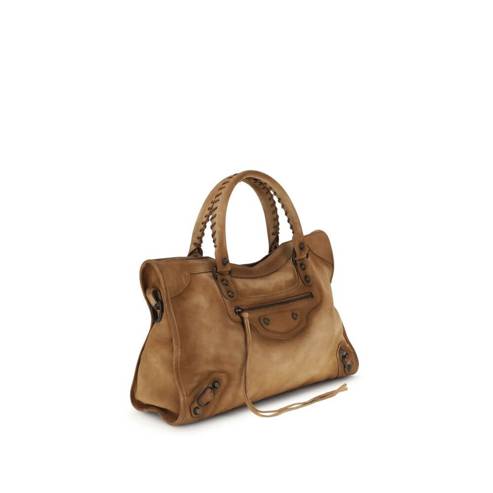 Beige Calf Leather Bos Taurus HandbagBalenciaga’s Le City medium Handbag, crafted in suede with a waxed effect, embodies elegance with a strong character. Featuring two hand-woven leather handles, it has a removable and adjustable shoulder strap for added