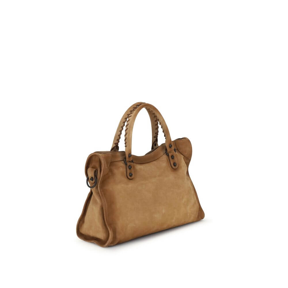 Beige Calf Leather Bos Taurus HandbagBalenciaga’s Le City medium Handbag, crafted in suede with a waxed effect, embodies elegance with a strong character. Featuring two hand-woven leather handles, it has a removable and adjustable shoulder strap for added