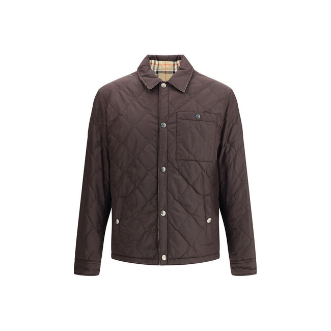 Brown Polyamide CoatBurberry’s Reversible quilted Jacket is a smock made of lightweight, water-resistant nylon with one side in solid color and the other in Burberry Check cotton twill. It features a regular fit and snap button closure with embossed logo.