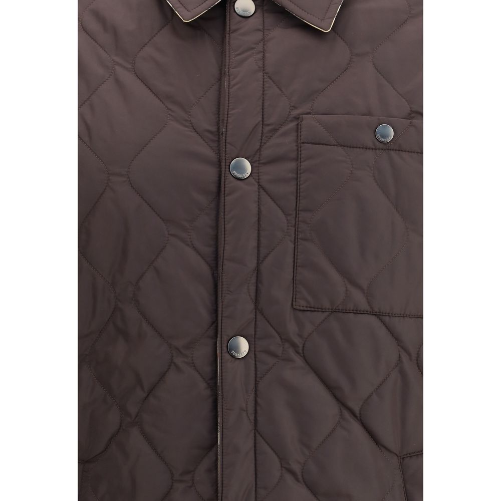 Brown Polyamide CoatBurberry’s Reversible quilted Jacket is a smock made of lightweight, water-resistant nylon with one side in solid color and the other in Burberry Check cotton twill. It features a regular fit and snap button closure with embossed logo.