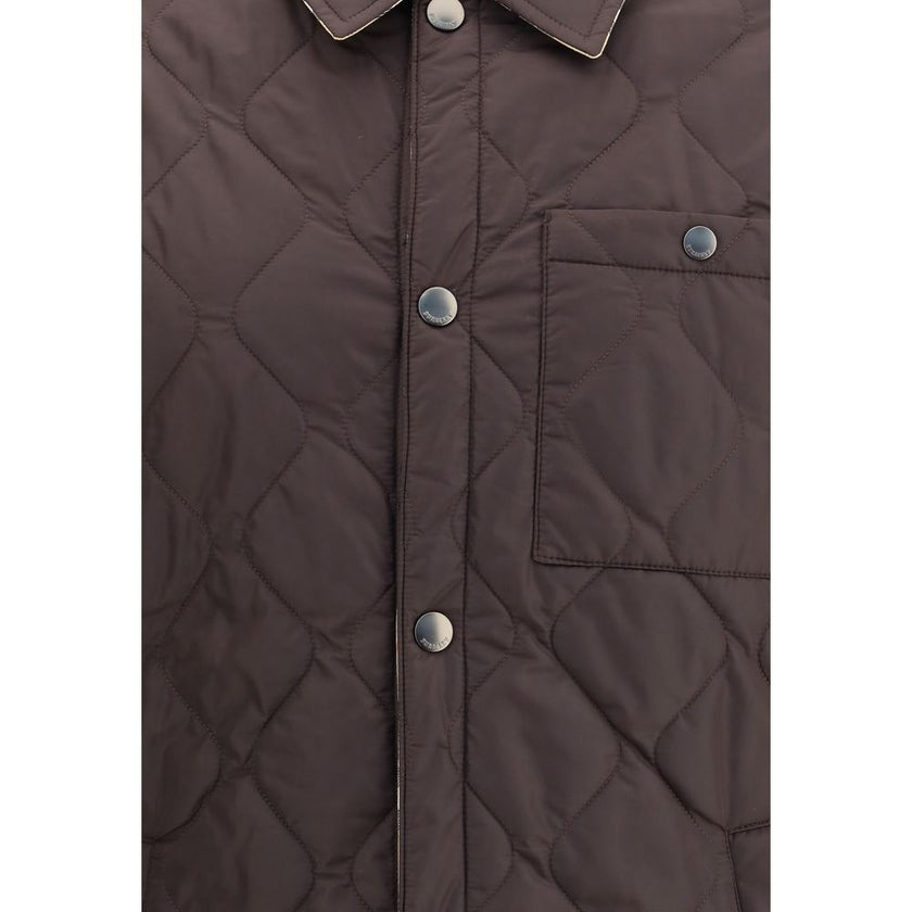 Brown Polyamide CoatBurberry’s Reversible quilted Jacket is a smock made of lightweight, water-resistant nylon with one side in solid color and the other in Burberry Check cotton twill. It features a regular fit and snap button closure with embossed logo.
