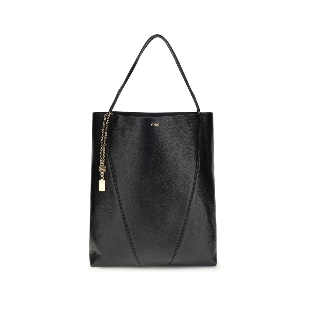 Black Calf Leather Bos Taurus Shoulder BagChloé’s Spin Large Tote Bag is crafted in glossy garnet cowhide and features a minimalist silhouette with graphic and elegant lines. A distinctive detail is the hanging chain with Chloé medals and the Horse emblem