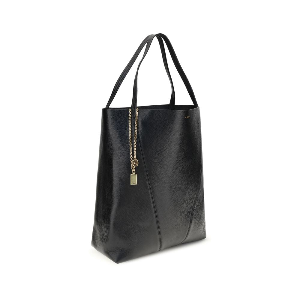 Black Calf Leather Bos Taurus Shoulder BagChloé’s Spin Large Tote Bag is crafted in glossy garnet cowhide and features a minimalist silhouette with graphic and elegant lines. A distinctive detail is the hanging chain with Chloé medals and the Horse emblem