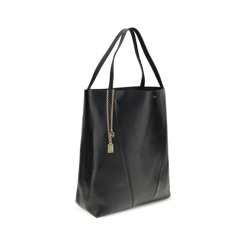 Black Calf Leather Bos Taurus Shoulder BagChloé’s Spin Large Tote Bag is crafted in glossy garnet cowhide and features a minimalist silhouette with graphic and elegant lines. A distinctive detail is the hanging chain with Chloé medals and the Horse emblem