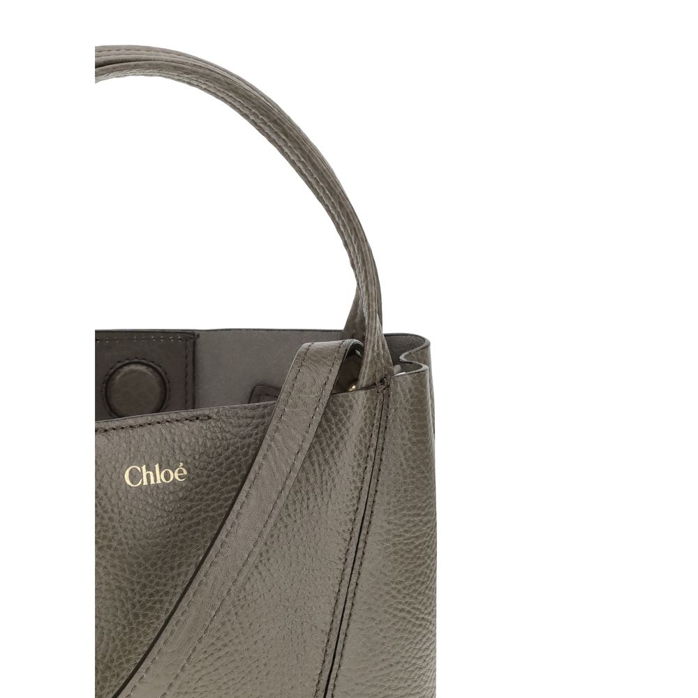 Gray Calf Leather Bos Taurus Shoulder BagThe Spin Shoulder Bag by Chloé, crafted by shiny grained leather, features an elegant design with two flat top handles and an adjustable shoulder strap. The closure is secured by a magnetic button, while the detail