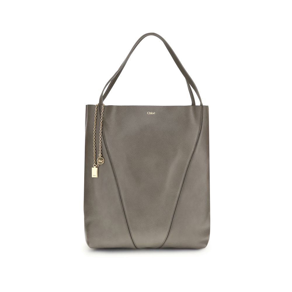 Gray Calf Leather Bos Taurus Shoulder BagChloé’s Spin Large Tote Bag is crafted in glossy garnet cowhide and features a minimalist silhouette with graphic and elegant lines. A distinctive detail is the hanging chain with Chloé medals and the Horse emblem,