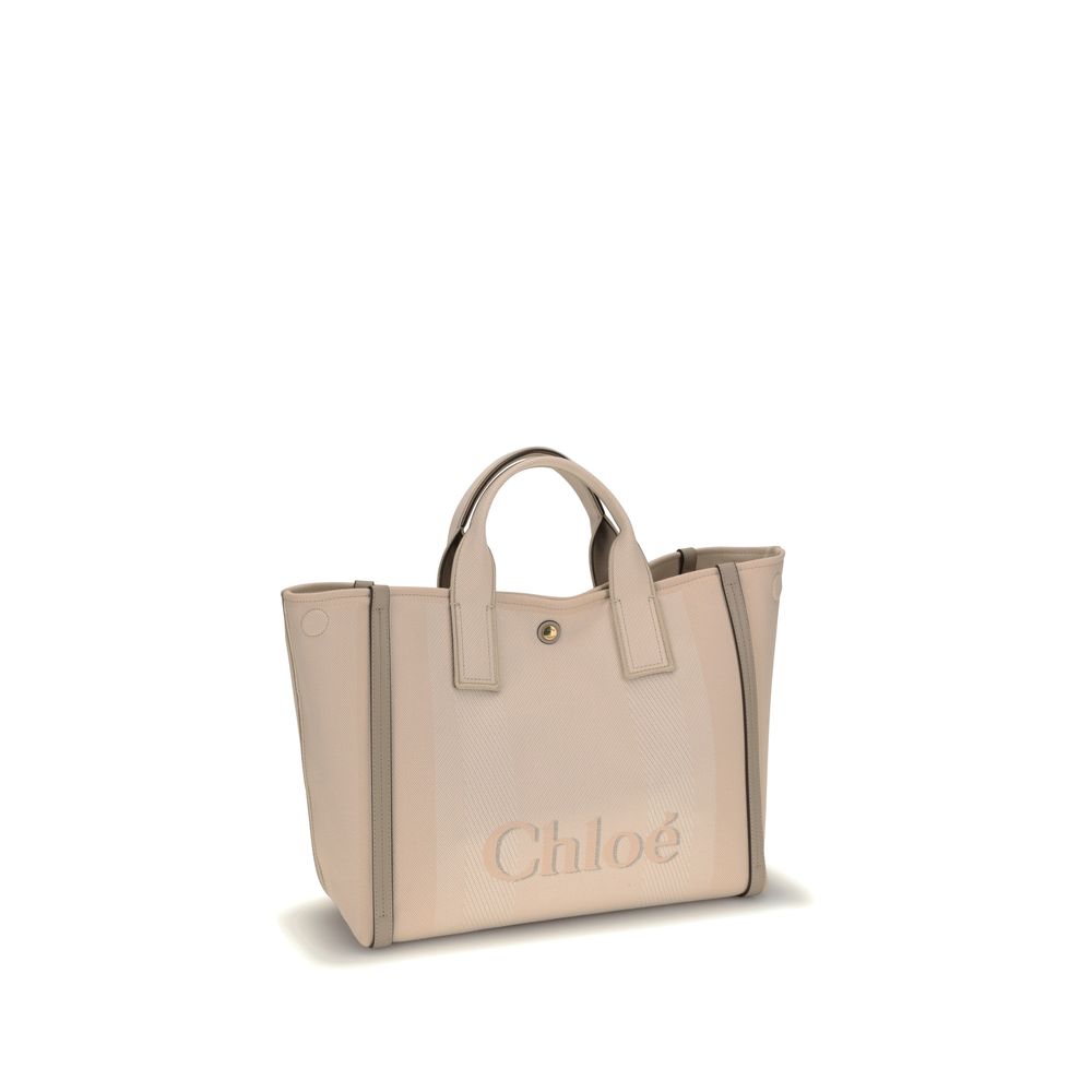 Beige Cotton HandbagChloé’s Carry Handbag is a refined and versatile accessory made of cotton with contrasting leather details that accentuate its elegance. The snap top closure provides practicality, while the double flat handles and leather extension on