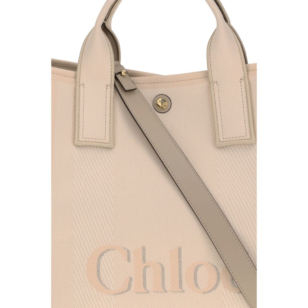 Beige Cotton HandbagChloé’s Carry Handbag is a refined and versatile accessory made of cotton with contrasting leather details that accentuate its elegance. The snap top closure provides practicality, while the double flat handles and leather extension on