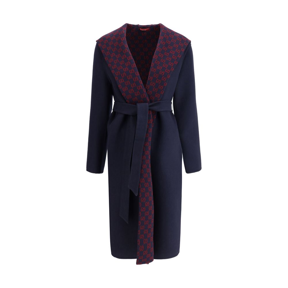 Blue Wool CoatGucci’s wool Coat is a long style with a timelessly elegant design. Featuring a hood and matching removable and knotted sash, it combines practicality and style. The two side welt pockets add functionality to the garment, while the iconic Gu