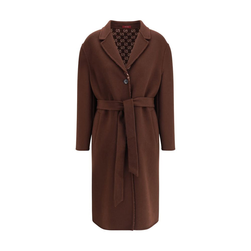 Brown Wool CoatGucci’s silk and wool reversible Coat is a refined and versatile piece, perfect for enhancing any look with a distinctive touch. Made of brown silk wool on one side and brown and light pink GG patterned silk wool on the other, it offers two