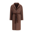 Brown Wool CoatGucci’s silk and wool reversible Coat is a refined and versatile piece, perfect for enhancing any look with a distinctive touch. Made of brown silk wool on one side and brown and light pink GG patterned silk wool on the other, it offers two