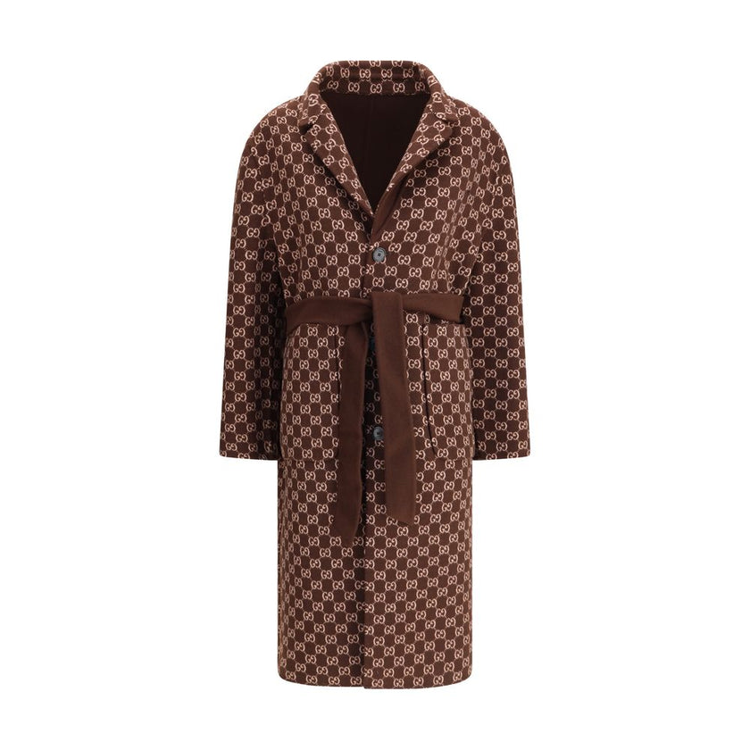 Brown Wool CoatGucci’s silk and wool reversible Coat is a refined and versatile piece, perfect for enhancing any look with a distinctive touch. Made of brown silk wool on one side and brown and light pink GG patterned silk wool on the other, it offers two