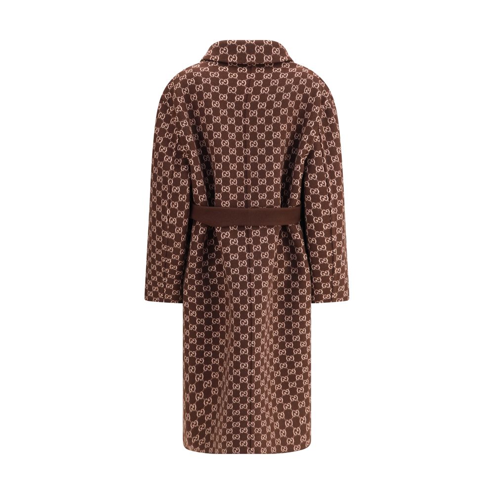 Brown Wool CoatGucci’s silk and wool reversible Coat is a refined and versatile piece, perfect for enhancing any look with a distinctive touch. Made of brown silk wool on one side and brown and light pink GG patterned silk wool on the other, it offers two