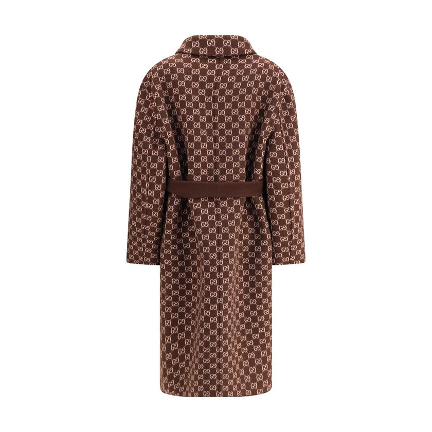 Brown Wool CoatGucci’s silk and wool reversible Coat is a refined and versatile piece, perfect for enhancing any look with a distinctive touch. Made of brown silk wool on one side and brown and light pink GG patterned silk wool on the other, it offers two