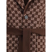 Brown Wool CoatGucci’s silk and wool reversible Coat is a refined and versatile piece, perfect for enhancing any look with a distinctive touch. Made of brown silk wool on one side and brown and light pink GG patterned silk wool on the other, it offers two