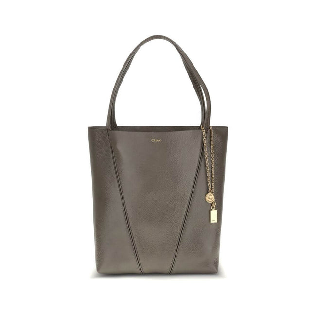 Spin Shoulder BagLeather Spin Shoulder Bag by Chloé is a refined and modern accessory featuring a sleek grained leather design. The two flat top handles offer a comfortable and practical grip, while the brand’s iconic monogram, press-stamped on the front,