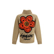 Beige Wool CardiganKenzo’s Futura zippered Cardigan is a knitted wool garment from the Kenzo x Futura 2000 collaboration. Featuring a shawl collar and a practical double-slider zipper, it has two front pockets and a striking graphic on the back that fuses