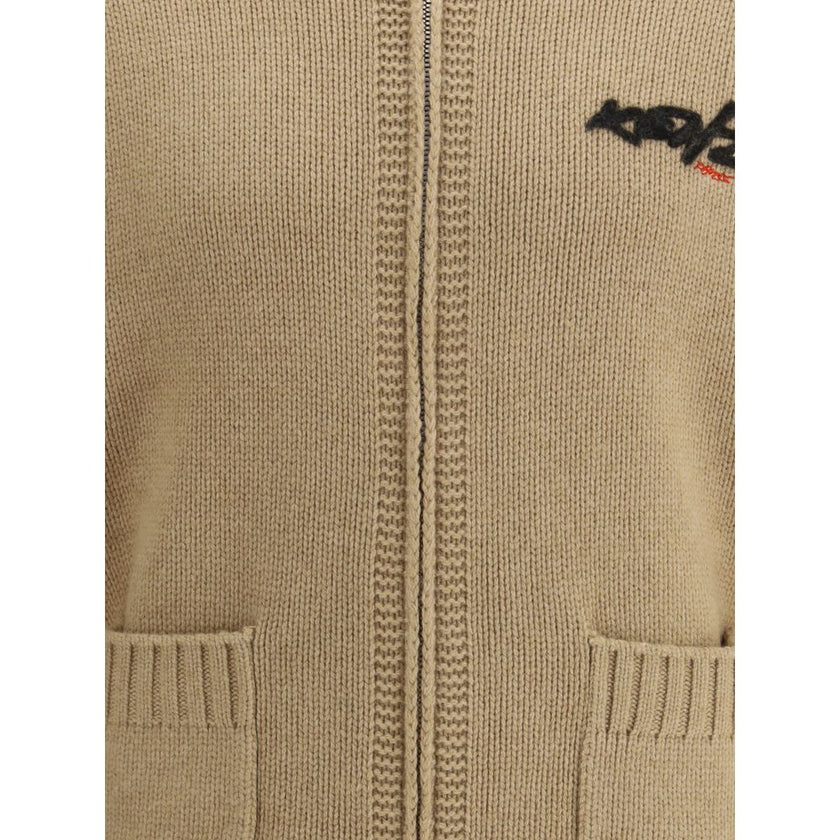 Beige Wool CardiganKenzo’s Futura zippered Cardigan is a knitted wool garment from the Kenzo x Futura 2000 collaboration. Featuring a shawl collar and a practical double-slider zipper, it has two front pockets and a striking graphic on the back that fuses