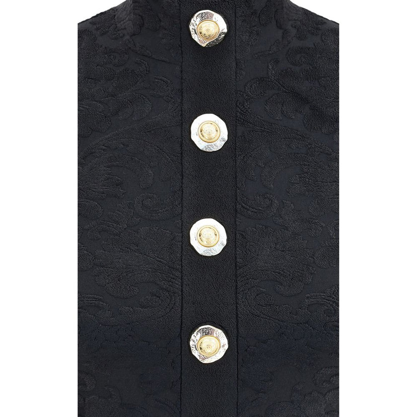 Black Viscose TopBalmain’s crop Top is a striking garment defined by an American neckline and a rich baroque pattern. Bare shoulders enhance the bust line, while decorative metal 