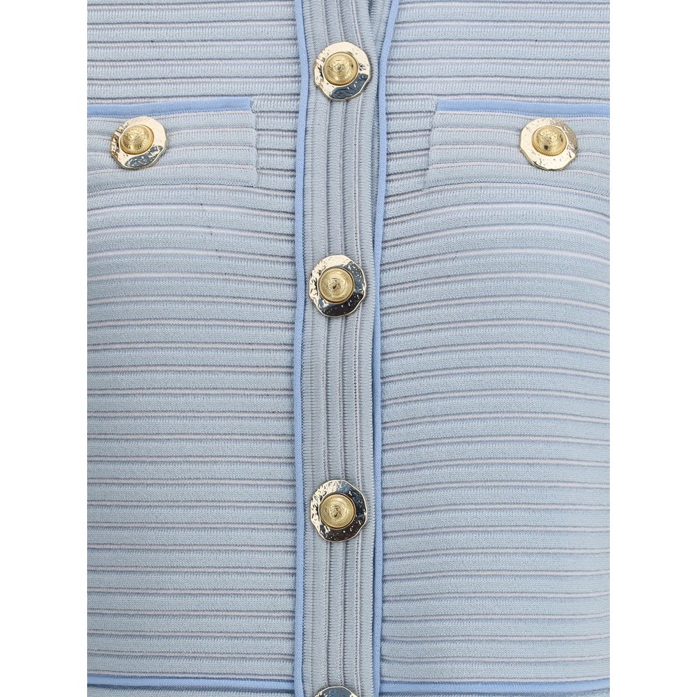 Light Blue Viscose CardiganBalmain’s Cardigan is a garment with a structured design and refined elegance. The front closure with five snap buttons is paired with two trompe-l’œil pockets enriched with decorative metal 