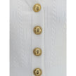Ribbed and braided CardiganBalmain’s Ribbed and braided Cardigan combines elegance and structure in a distinctive design. Featuring a V-neckline, it features structured shoulders with decorative tabs and buttons, recalling the military aesthetic dear to t