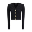 Black Viscose CardiganBalmain’s Ribbed and braided Cardigan combines elegance and structure in a distinctive design. Featuring a V-neckline, it features structured shoulders with decorative tabs and buttons, recalling the military aesthetic dear to the Ma