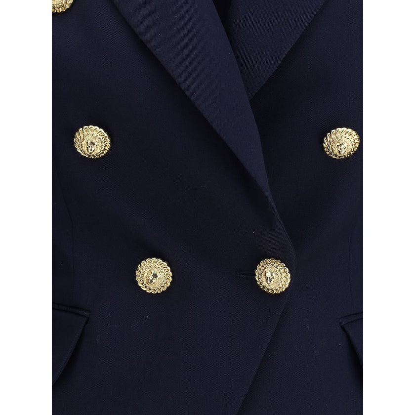 Blue Fleece Wool BlazerThe Balmain double-breasted Blazer is an icon of structured and decisive style. Characterized by stiff shoulders and peak lapels, it enhances the silhouette with an impeccable tailoring line. The front closure with gold embossed but