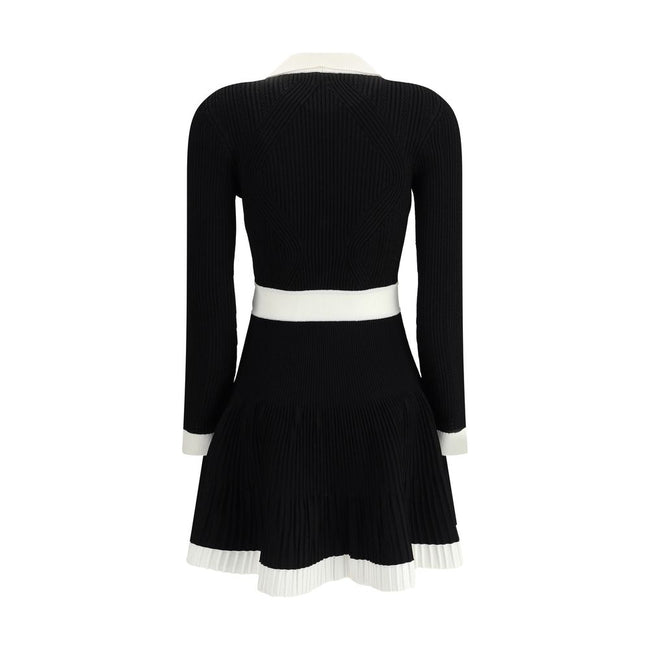 Black Viscose Casual DressBalmain’s Knit Short Dress combines structured elegance and comfort. Made of stretch knit, it features a feminine silhouette with a flared skirt, collar and ribbed trim. The front closure is embellished with embossed buttons, the