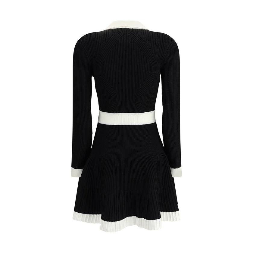 Black Viscose Casual DressBalmain’s Knit Short Dress combines structured elegance and comfort. Made of stretch knit, it features a feminine silhouette with a flared skirt, collar and ribbed trim. The front closure is embellished with embossed buttons, the