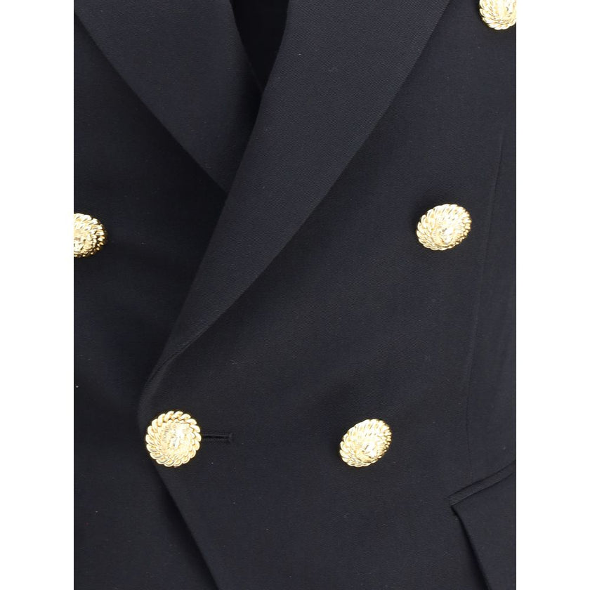 Black Wool BlazerBalmain’s double-breasted Blazer is a sartorial statement piece, embellished with embossed buttons that recall the house’s iconic aesthetic. The crop design enhances the figure, while the wide peaked lapels lend a touch of decisive elegan