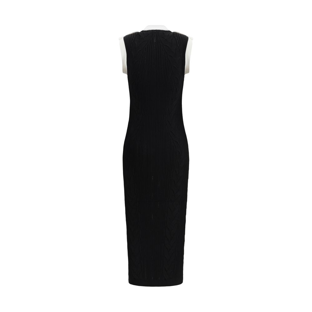 Black Viscose Casual DressBalmain’s Long Dress is a bold and refined garment made of a twisted knit with openwork that enhances the silhouette. The round neckline is framed by a contrasting ribbed finish, also echoed on the armholes. The contrasting strap