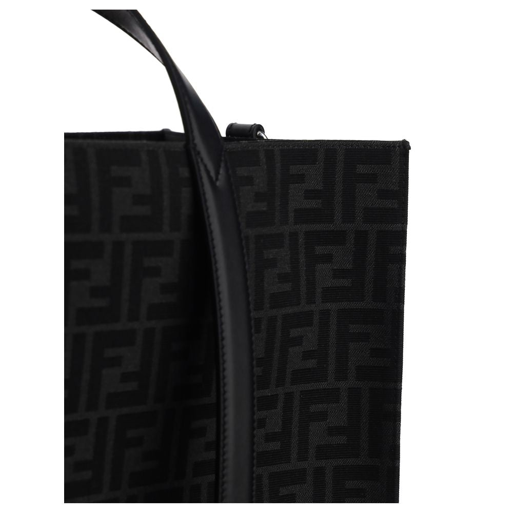 Black Polyester Shoulder BagThe Tote Handbag by Fendi features a double rigid handle at the top, a removable and adjustable leather shoulder strap, and an internal welt pocket with a zipper closure. The exterior is adorned with the brand’s iconic FF print
