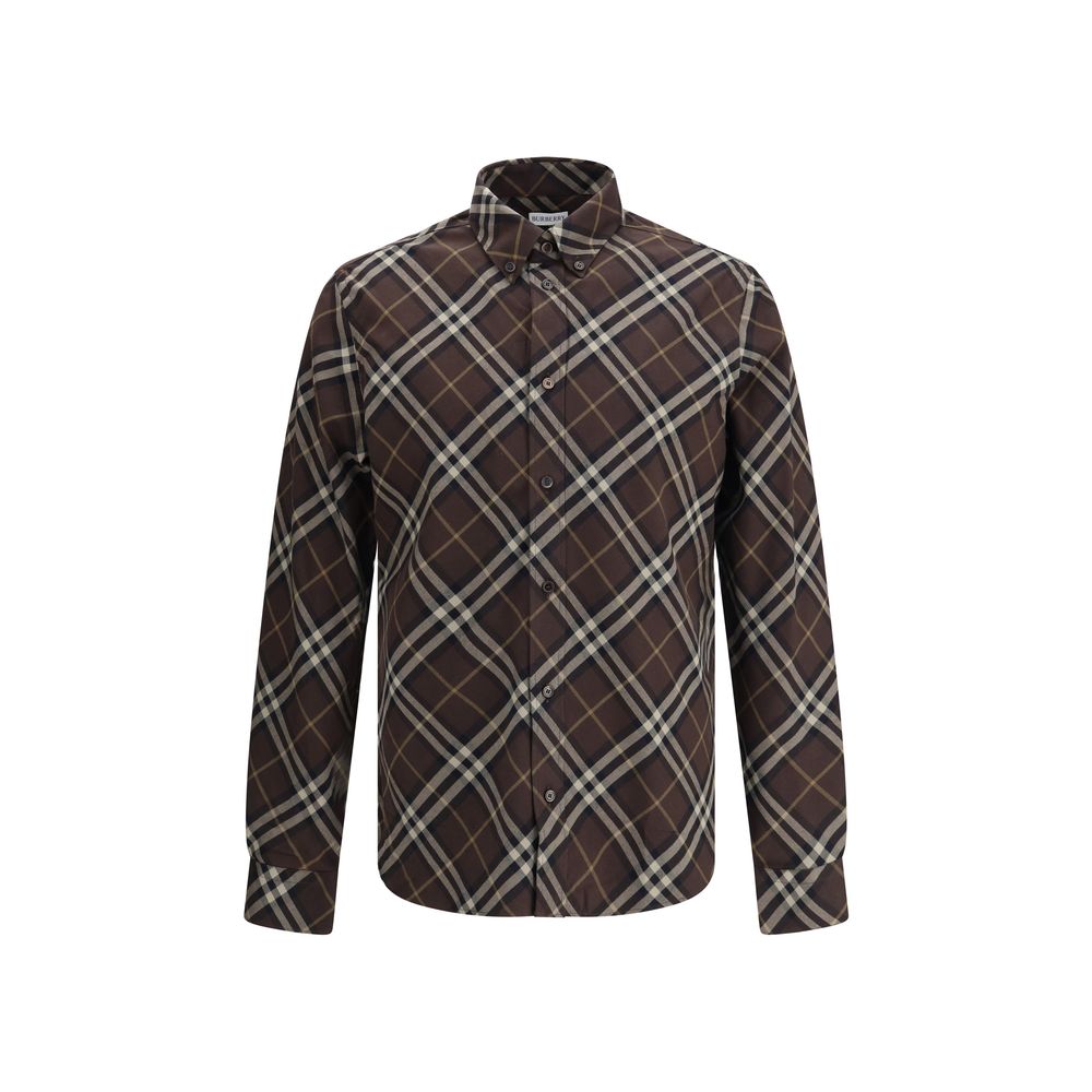 Brown Cotton Pattern ShirtBurberry’s Check cotton flannel Shirt is a timeless classic that combines tradition and contemporary style. Made of soft cotton flannel woven with the famous Burberry Check pattern, it features long sleeves, a button-down collar