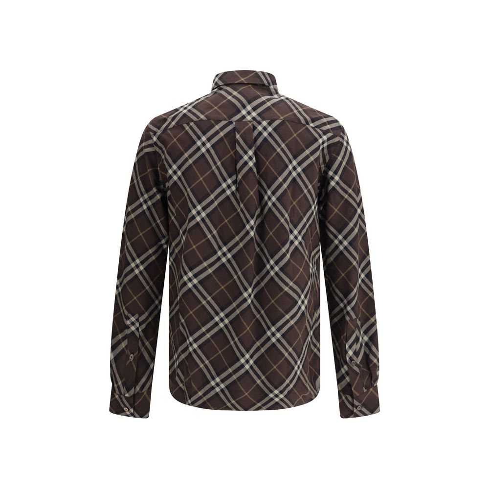 Brown Cotton Pattern ShirtBurberry’s Check cotton flannel Shirt is a timeless classic that combines tradition and contemporary style. Made of soft cotton flannel woven with the famous Burberry Check pattern, it features long sleeves, a button-down collar