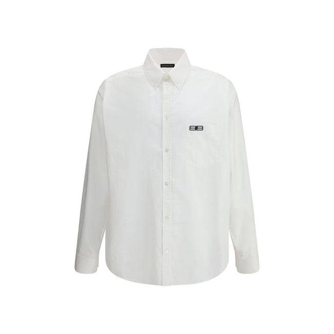 White Cotton Dress ShirtBalenciaga’s oversized cotton Shirt features a contemporary and striking design. It features a front button closure, a classic collar and an asymmetrical hem that adds dynamism to the silhouette. A small patch pocket on the front,