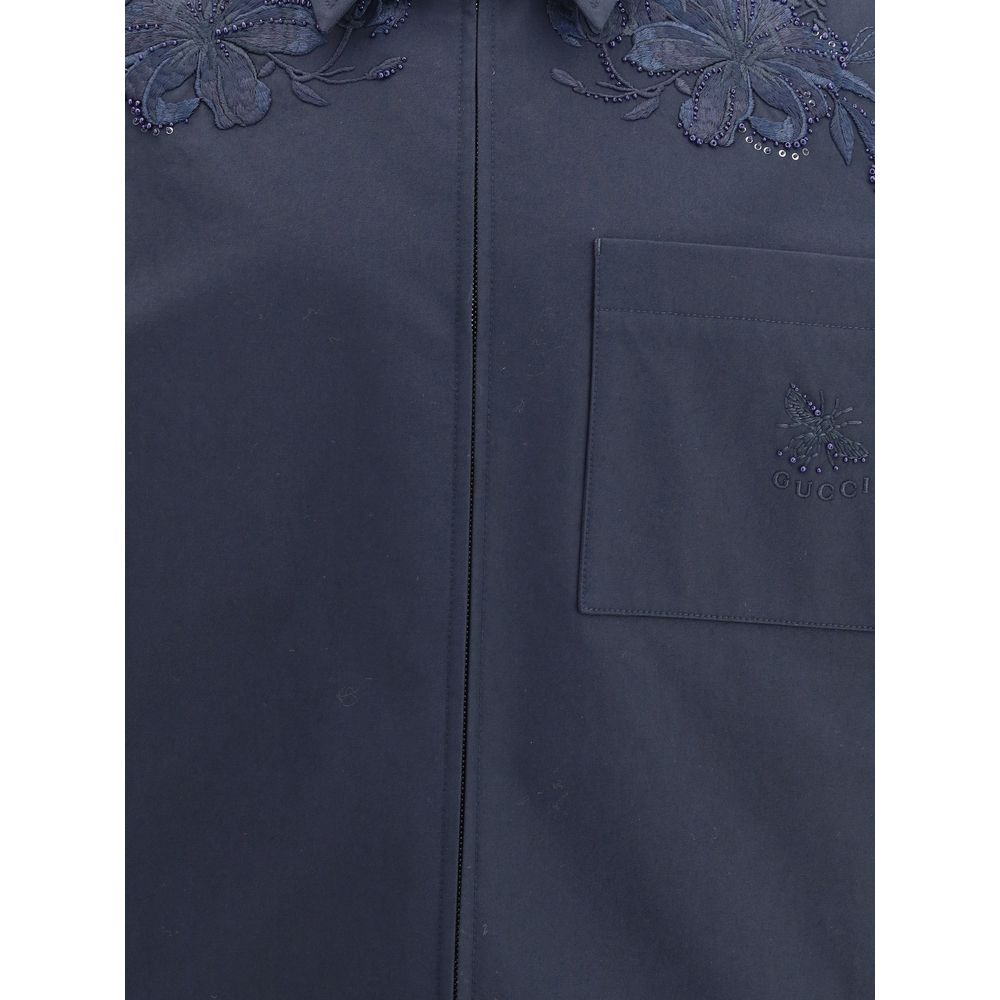 Blue Cotton Denim JacketGucci’s cotton Jacket with embroidery is made of black cotton twill, featuring a Web detail on the back and an embossed Gucci logo to highlight its identity. It features a pointed collar, functional front pockets and long sleeves,