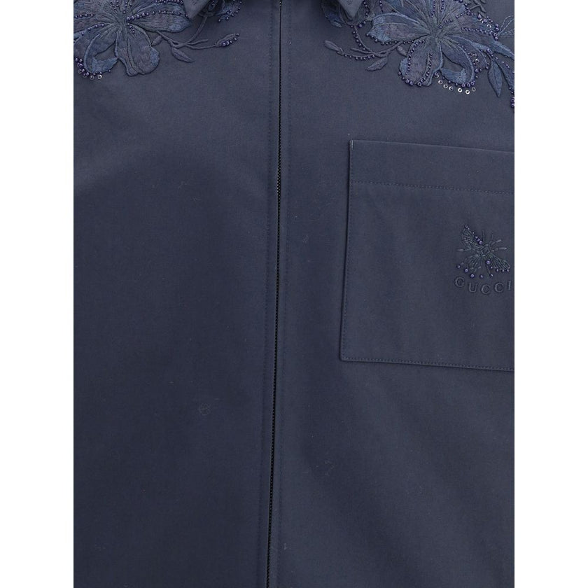 Blue Cotton Denim JacketGucci’s cotton Jacket with embroidery is made of black cotton twill, featuring a Web detail on the back and an embossed Gucci logo to highlight its identity. It features a pointed collar, functional front pockets and long sleeves,