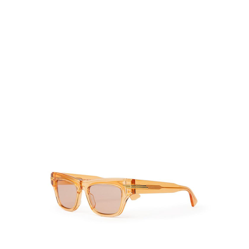 Orange Acetate SunglassesBottega Veneta Orange Recycled Acetate Sunglasses. Transparent crystal effect frame, orange lens, gold details on the temples Composition: Acetate Internal SKU: 25GIU77 Brand SKU: 669573V2Q307505Orange Acetate Sunglasses${tagsBott