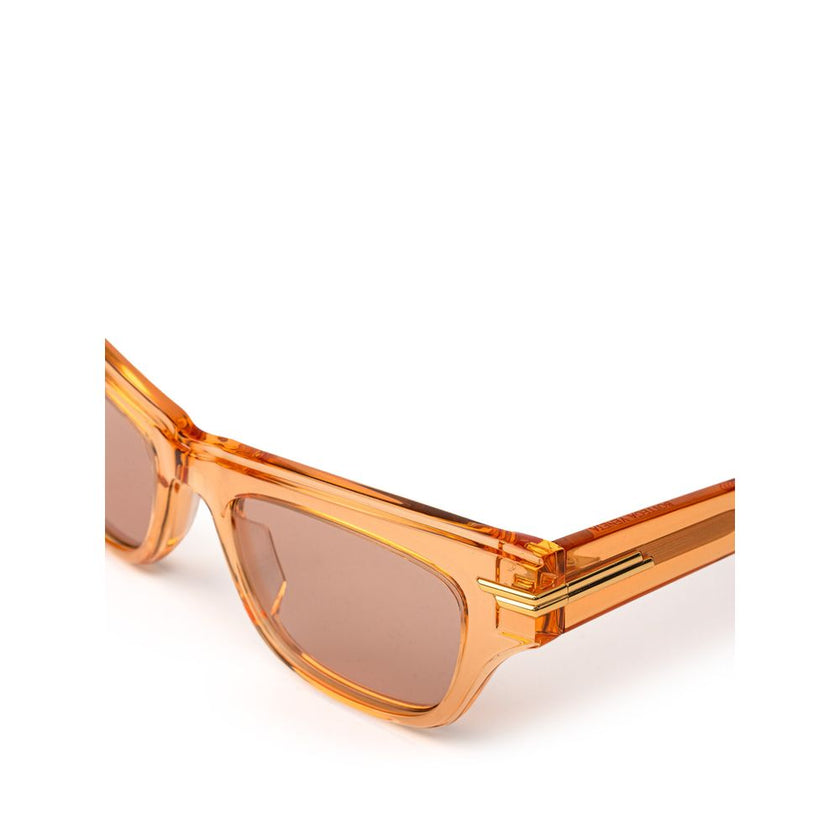 Orange Acetate SunglassesBottega Veneta Orange Recycled Acetate Sunglasses. Transparent crystal effect frame, orange lens, gold details on the temples Composition: Acetate Internal SKU: 25GIU77 Brand SKU: 669573V2Q307505Orange Acetate Sunglasses${tagsBott