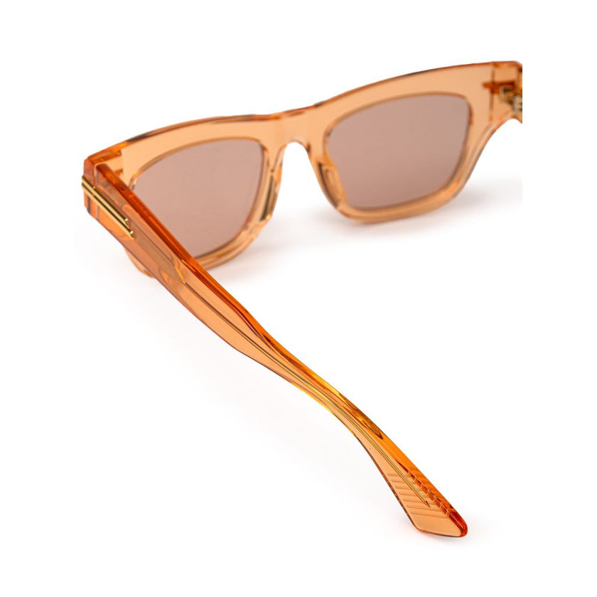 Orange Acetate SunglassesBottega Veneta Orange Recycled Acetate Sunglasses. Transparent crystal effect frame, orange lens, gold details on the temples Composition: Acetate Internal SKU: 25GIU77 Brand SKU: 669573V2Q307505Orange Acetate Sunglasses${tagsBott