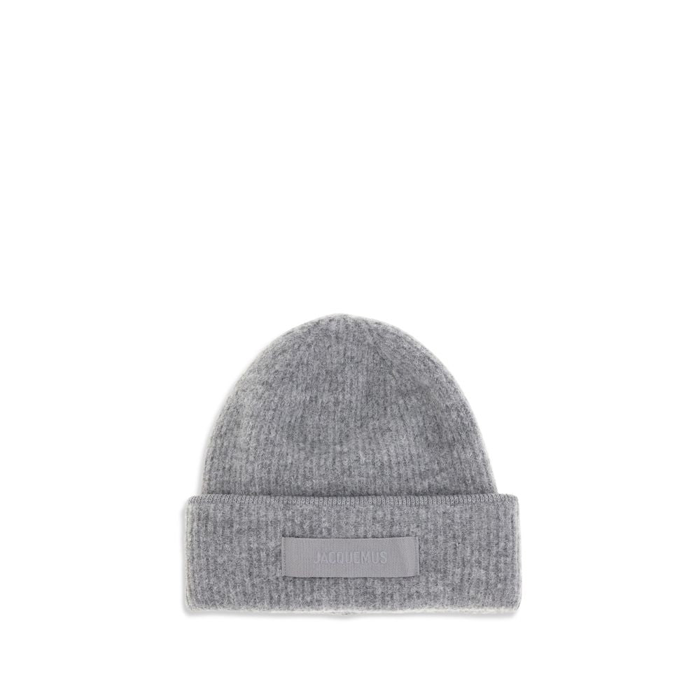 Gros Grain Ribbed BeanieThe Gros Grain Ribbed Beanie by Jacquemus combines style and functionality. The adjustable fit ensures comfort, while the contrasting folded brim and tone-on-tone gros-grain logo embroidered on the front complete the design with a