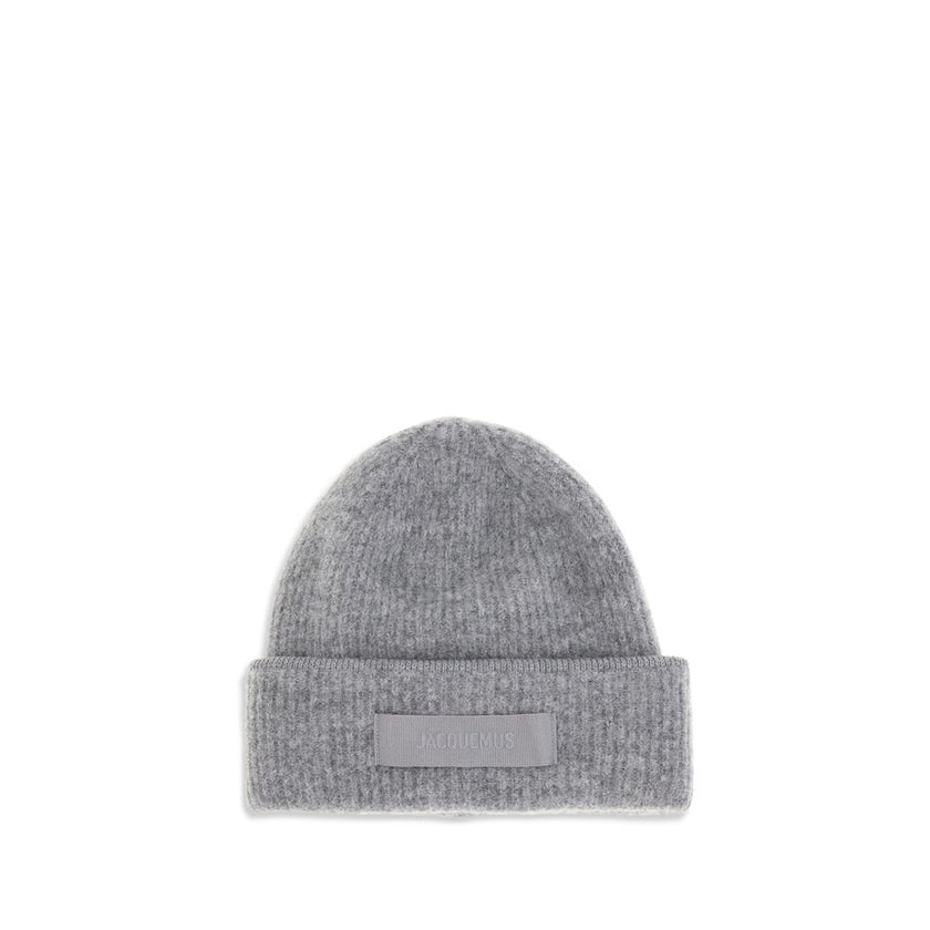 Gros Grain Ribbed BeanieThe Gros Grain Ribbed Beanie by Jacquemus combines style and functionality. The adjustable fit ensures comfort, while the contrasting folded brim and tone-on-tone gros-grain logo embroidered on the front complete the design with a