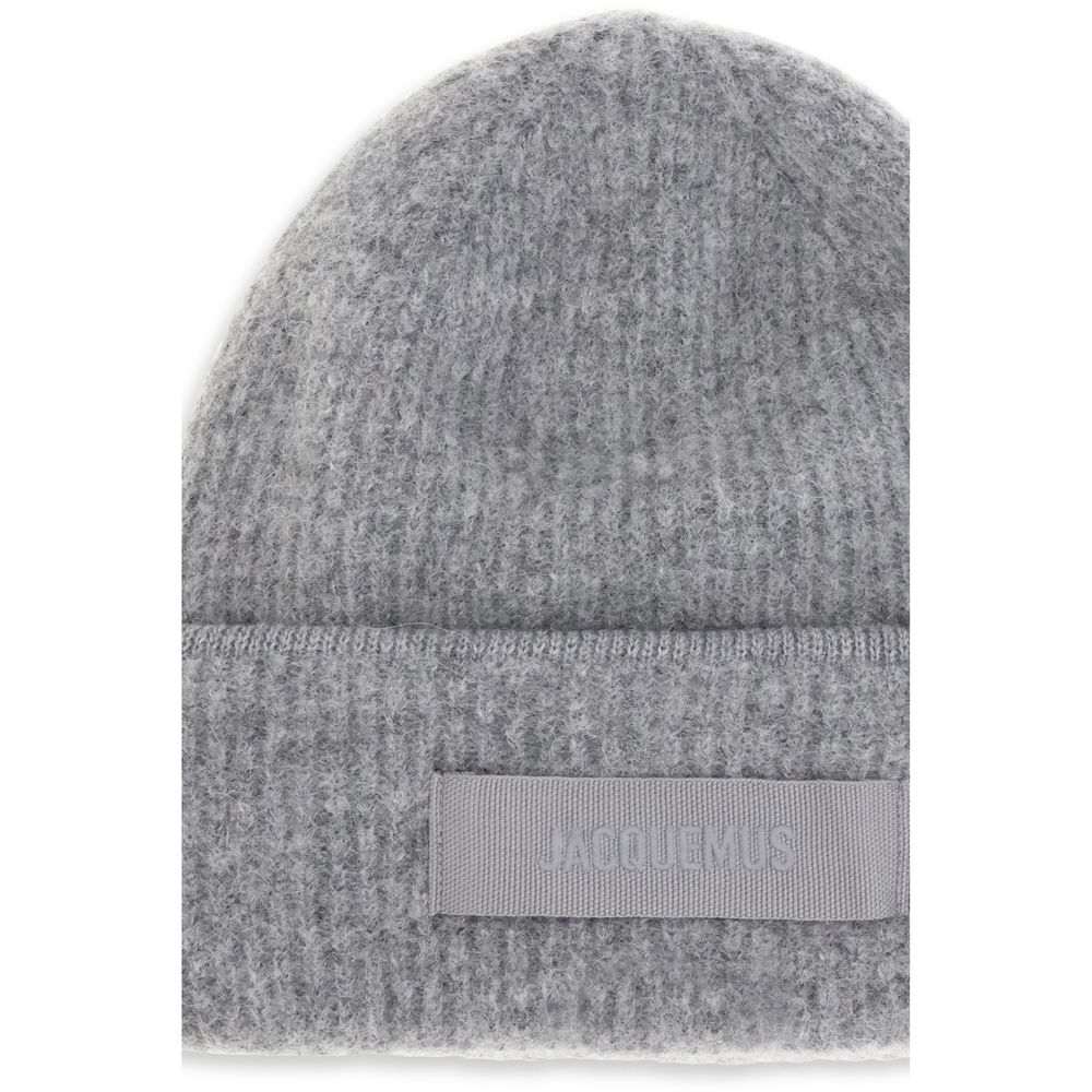 Gros Grain Ribbed BeanieThe Gros Grain Ribbed Beanie by Jacquemus combines style and functionality. The adjustable fit ensures comfort, while the contrasting folded brim and tone-on-tone gros-grain logo embroidered on the front complete the design with a