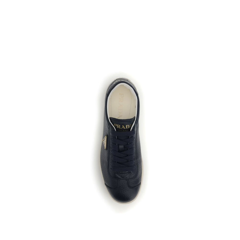 Blue Calf Leather Bos Taurus Low Top SneakersPrada’s leather Sneakers are made of fine grained deerskin leather and feature an embossed logo on the back, along with the iconic logo triangle on the side. They feature a lace-up closure, a logo-printed tongu