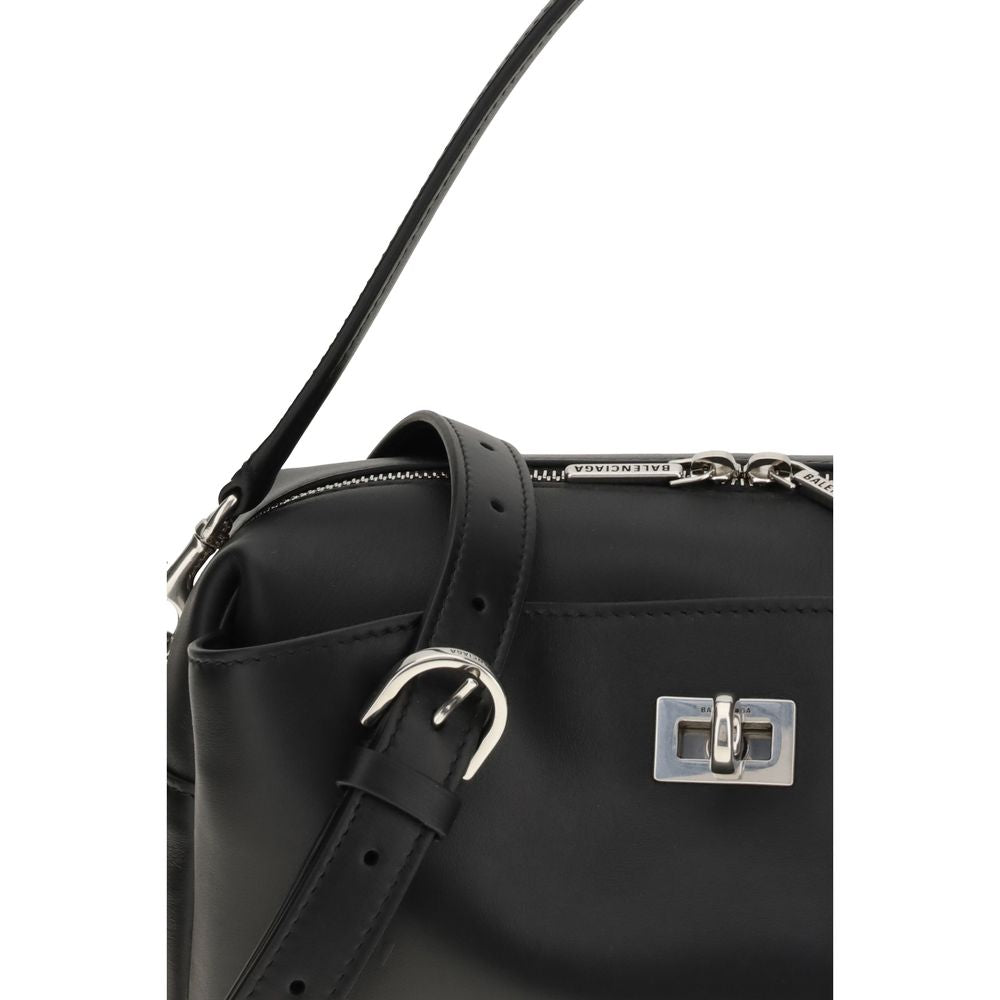 Black Calf Leather Bos Taurus Shoulder BagThe Rodeo Camera Bag by Balenciaga is crafted from smooth black calf leather with antique silver-tone hardware. Versatile and practical, it can be worn crossbody, over the shoulder, or by hand, thanks to the remov
