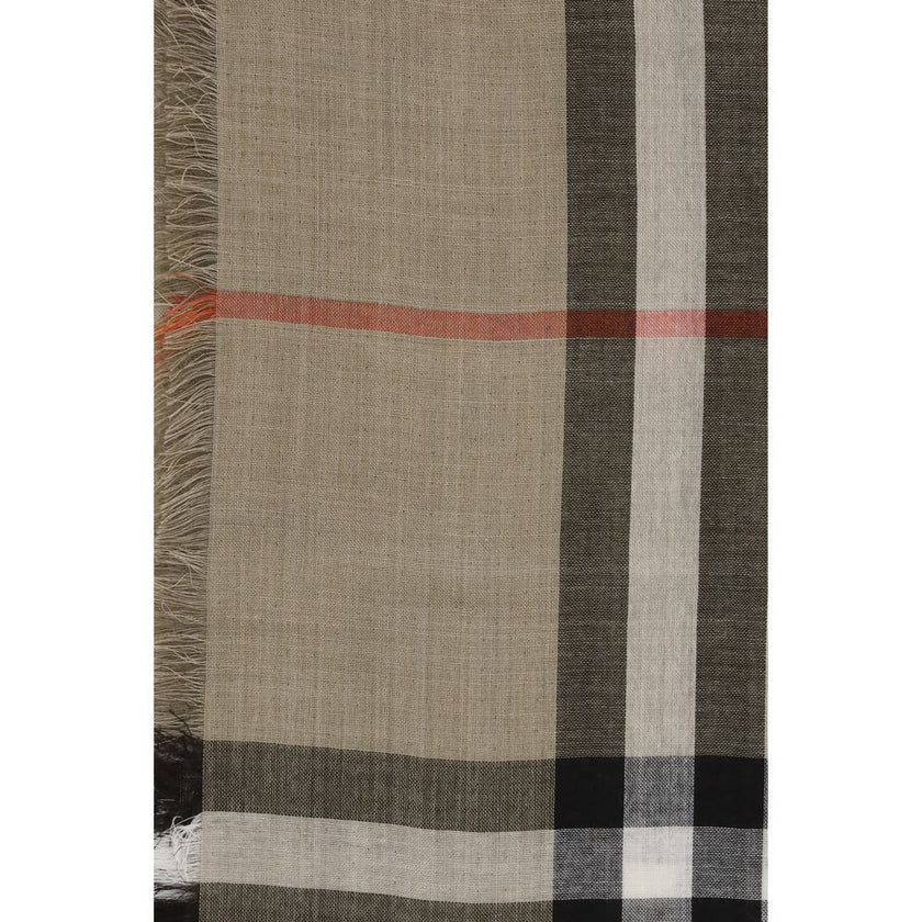 Beige Wool ScarfThe Burberry Check Reversible Wool and Silk Scarf is crafted in lightweight muslin in Italy. This rectangular scarf features the Burberry Check print in seasonal sand and brown Vole tones, with short, delicate fringes along the edges, comb