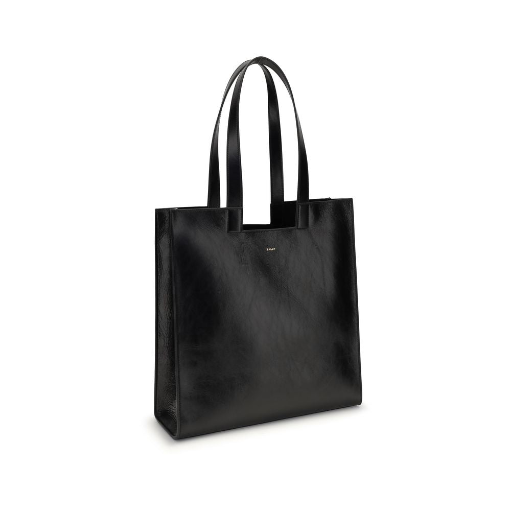 Black Calf Leather Bos Taurus Shoulder BagThe Bally Tote Bag is reimagined in a simple, minimalist style, featuring clean lines and a versatile shape suitable for any occasion. Made from calf leather with crêpe finishes, it features a gold-laminated logo,